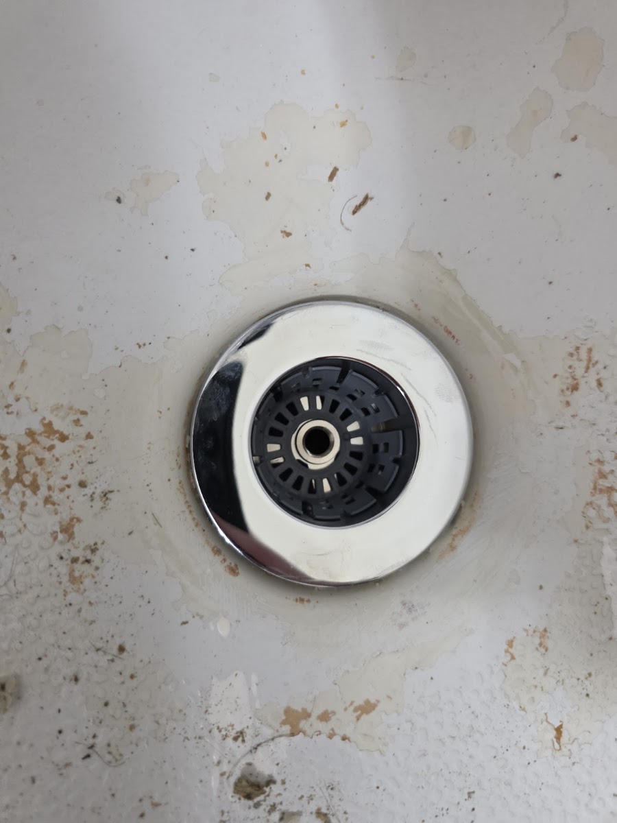 Finished drain strainer installed in a bathtub